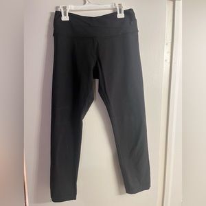 Black cropped lululemon leggings with crossed waist band